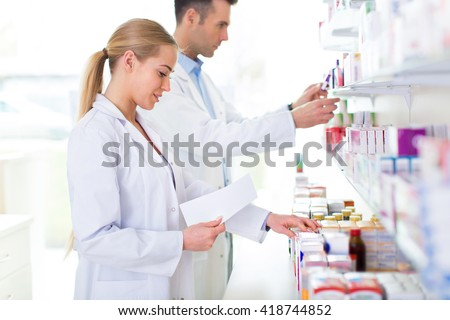 Female and male pharmacists in pharmacy
