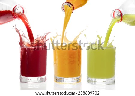 Fruit juices poured from bottles Kiwi, currants, orange