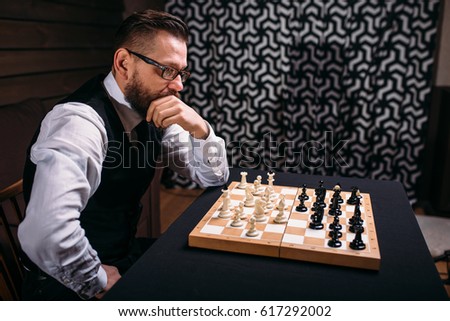 Pensive chess player thinking about game strategy