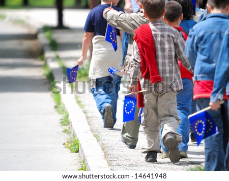 childrens group with EU flags walking ahead