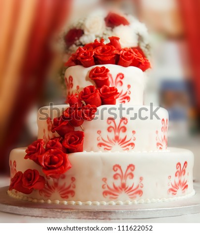 Wedding cake with red roses - stock photo