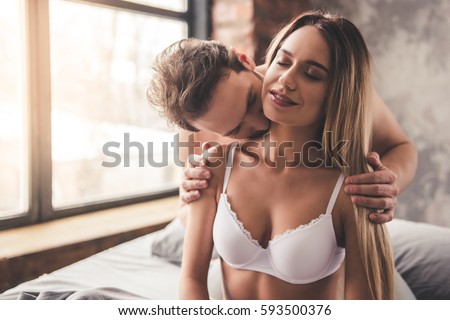 https://thumb9.shutterstock.com/display_pic_with_logo/559060/593500376/stock-photo-beautiful-couple-is-smiling-and-hugging-while-spending-time-together-in-bed-at-home-man-is-kissing-593500376.jpg