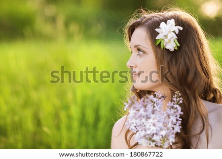 https://thumb9.shutterstock.com/display_pic_with_logo/559519/180867722/stock-photo-beautiful-woman-with-flowers-in-spring-sunshine-girl-is-holding-a-lillac-on-the-green-meadow-180867722.jpg