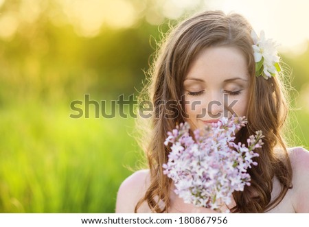 https://thumb9.shutterstock.com/display_pic_with_logo/559519/180867956/stock-photo-beautiful-woman-with-flowers-in-spring-sunshine-girl-is-holding-a-lillac-on-the-green-meadow-180867956.jpg