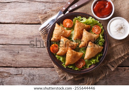 Samosa On A Plate With Sauce And Tomatoes Horizontal View From Above Rustic Style Samosa On A Plate With Sauce And Tomatoes Horizontal View From Above Rustic Style