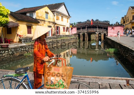 Hoi An, central Vietnam. February 25, 2013. . Ancient Vietnamese city of Hoi An. River in the city center. The background is a historic landmark Japanese Bridge. Hoi An, Vietnam