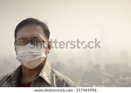 Asian man wearing mouth mask against air pollution