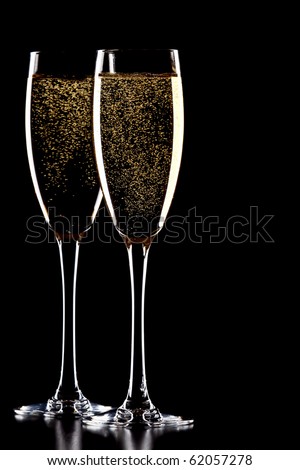 A glass of champagne, isolated on a black background.