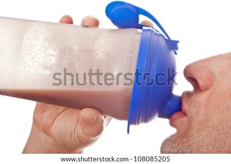 Man holding and drinking the post workout chocolate whey protein shake, isolated on white
