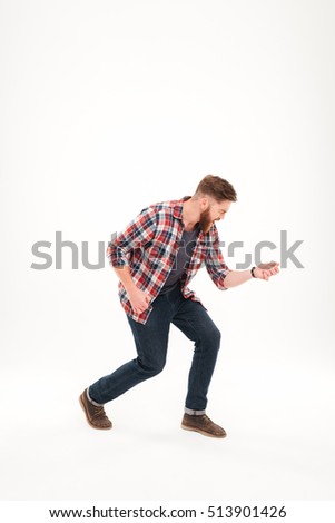 Full length of a casual bearded man in plaid shirt playing air guitar isolated on a white background
