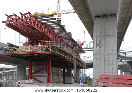 Bridge construction with scaffolding forms over intersection road