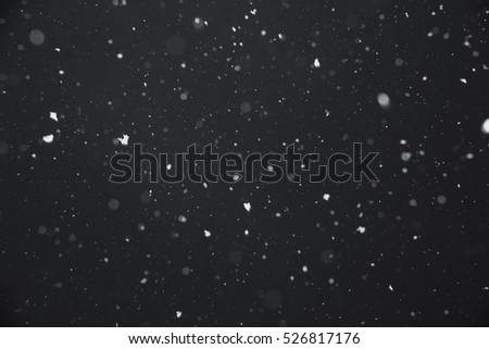 Falling snow on black background