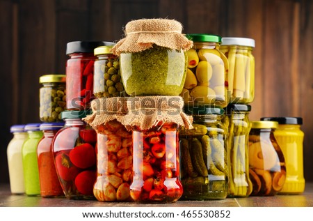 Jars with variety of pickled vegetables. Preserved food