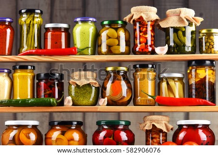 Jars with variety of pickled vegetables. Preserved food