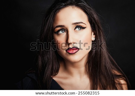 High fashion look.glamor portrait of beautiful sexy stylish Caucasian young woman model in black cloth with bright makeup