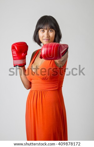 https://thumb9.shutterstock.com/display_pic_with_logo/599572/409878172/stock-photo-young-sexy-filipino-woman-wearing-a-low-cut-orange-dress-throwing-a-punch-409878172.jpg