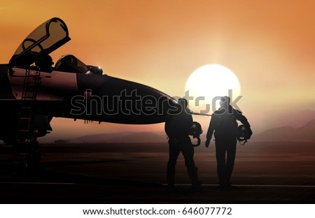 Fighter pilot and supersonic jet on military airbase during sunset