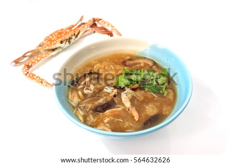 Braised fish maw in red gravy abalone mushroom with crab meat, The presentation is white background and steamed crab out focus.