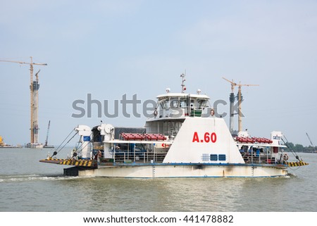 Cao Lanh, Vietnam - March 17, 2016: Car ferries in the Mekong Delta of Vietnam are rapidly being replaced by motorway bridges, like here near Cao Lanh, the capital of Dong Thap Province.