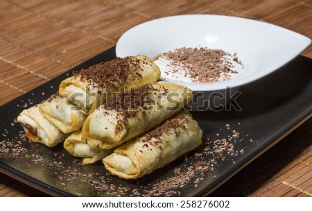 Chocolate and banana spring rolls - bite size treats, filled with banana and chocolate, served with cream