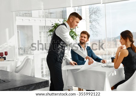 https://thumb9.shutterstock.com/display_pic_with_logo/614404/355992122/stock-photo-dinner-in-restaurant-waiter-serving-happy-romantic-young-couple-in-love-cheerful-people-making-355992122.jpg