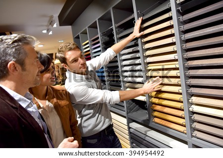 Couple with salesman in kitchen furniture store