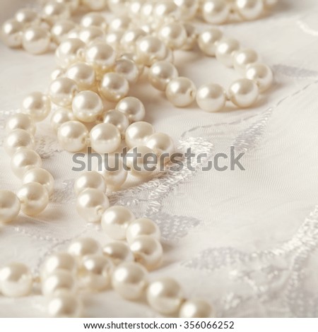 wedding pearl necklace on white floral background