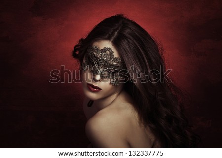 sensual beautiful young woman with lace mask, studio shot