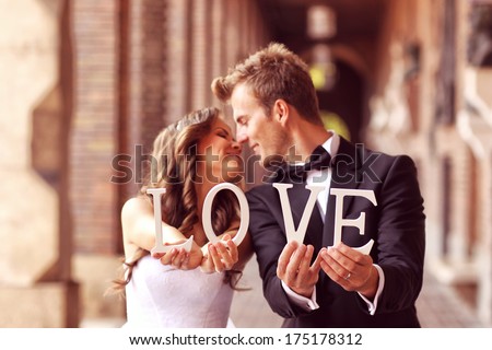 https://thumb9.shutterstock.com/display_pic_with_logo/639644/175178312/stock-photo-happy-bride-and-groom-holding-love-letters-175178312.jpg