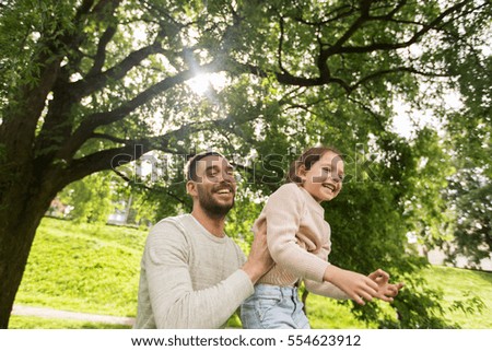 family, parenthood, fatherhood and people concept - happy father and little girl having fun in summer park
