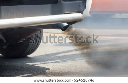 Air pollution from vehicle exhaust pipe on road