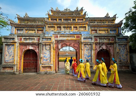 HUE, VIETNAM - May 1, 2014 : People in traditional costumes walk under an archway in the Imperial City of Hue, Vietnam.