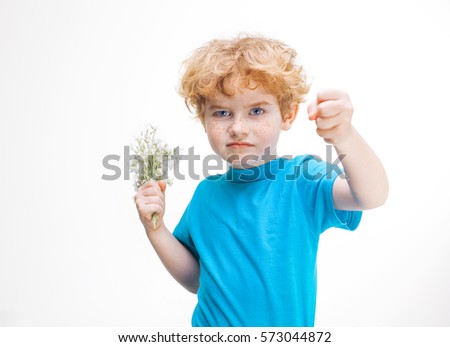 Boy tired to give flowers on International Women's Day, child shows a fist, March 8, Mother's Day, Valentine's Day, schoolboy in the blue shirt isolated on white background
