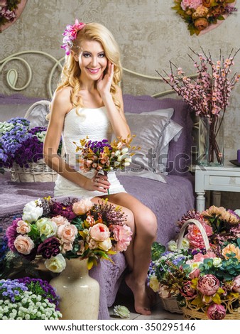 https://thumb9.shutterstock.com/display_pic_with_logo/657433/350295146/stock-photo-beautiful-russian-blonde-girl-sitting-on-a-bed-with-a-purple-blanket-and-around-a-lot-of-baskets-350295146.jpg