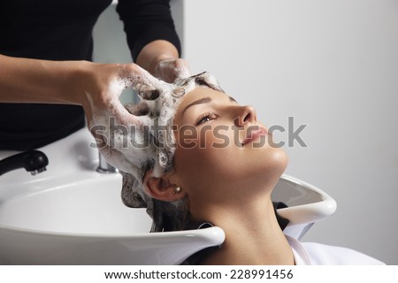 woman getting a hair wash procedure in salon