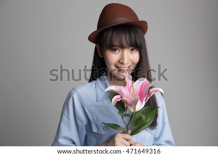 https://thumb9.shutterstock.com/display_pic_with_logo/699607/471649316/stock-photo-young-beautiful-asian-woman-holding-lily-flower-in-her-hand-471649316.jpg