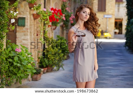 https://thumb9.shutterstock.com/display_pic_with_logo/71188/198673862/stock-photo-beautiful-woman-in-summer-dress-walking-and-running-joyful-and-cheerful-smiling-in-tuscany-italy-198673862.jpg