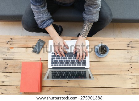 hipster guy using his laptop outdoors and relaxing