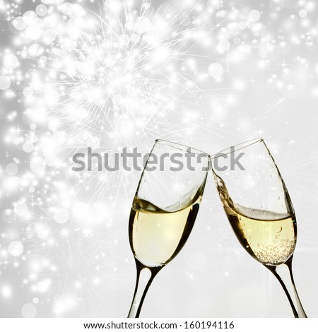 Glasses with champagne against holiday lights - stock photo