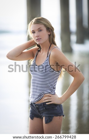 https://thumb9.shutterstock.com/display_pic_with_logo/732160/266799428/stock-photo-attractive-young-portrait-woman-posing-in-cut-off-shorts-with-one-arm-on-her-head-266799428.jpg