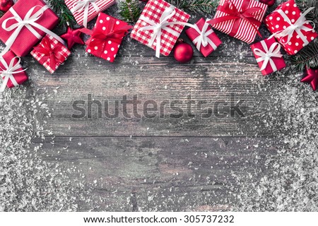Christmas background with decorations and gift boxes on wooden board
