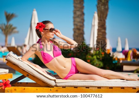 http://thumb9.shutterstock.com/display_pic_with_logo/745759/100477612/stock-photo-woman-sunbathing-in-bikini-at-tropical-travel-resort-beautiful-young-woman-lying-on-sun-lounger-100477612.jpg