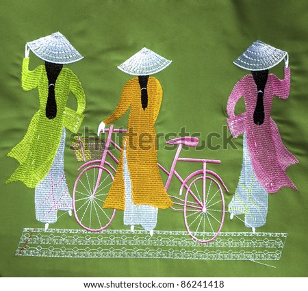 traditional Vietnamese particulars i.e. Ao Dai, hat and bicycle embroidered on a cloth as souvenir available for sale