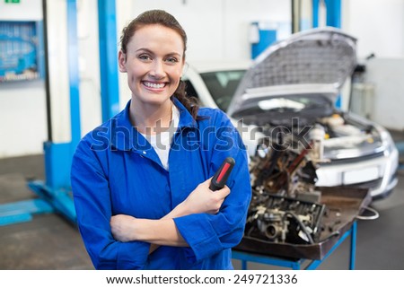 Mechanic smiling at the camera at the repair garage