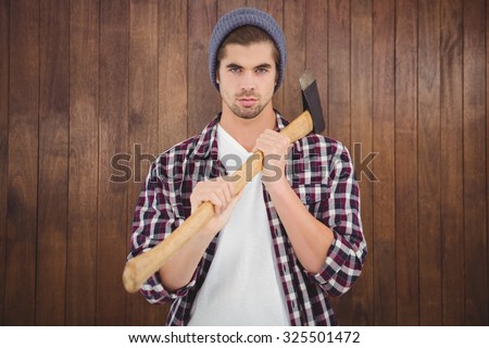 stock-photo-portrait-of-confident-man-holding-axe-on-shoulder-while-standing-against-wooden-wall-325501472.jpg