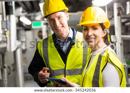 Engineers working in temperature control room of large building