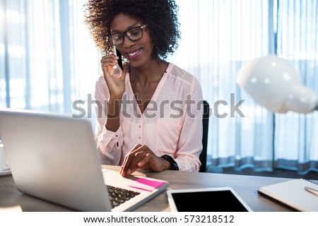 Business woman on the phone at office