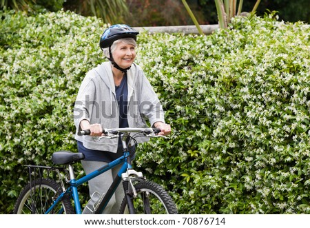 stock-photo-mature-woman-walking-with-her-mountain-bike-70876714.jpg