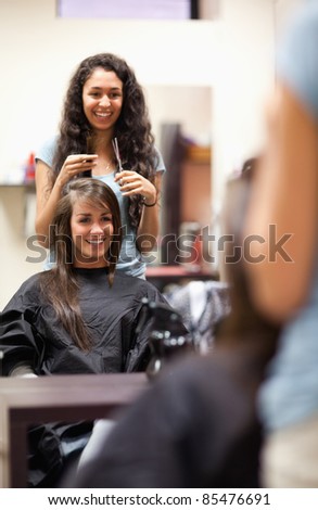Portrait of a woman making a haircut standing up