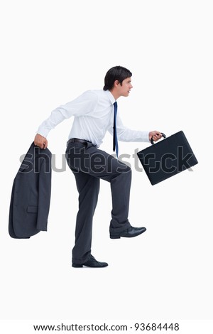 Side view of walking tradesman with suitcase and jacket against a white ...